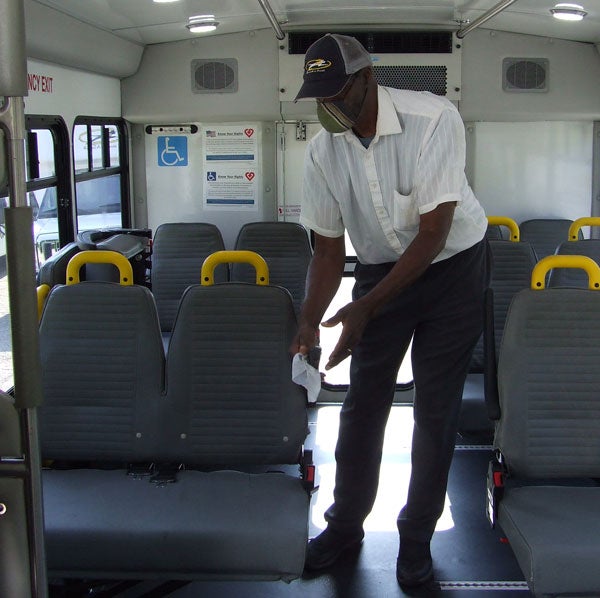 VAC Driver Willie Moore cleaning bus seats, 2020.