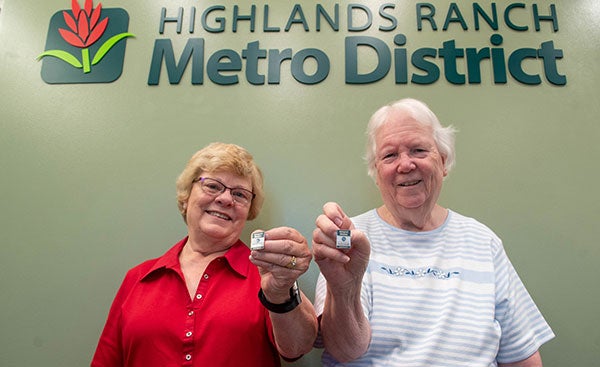 Two Highlands Ranch Senior Center inaugural members show off their new pins