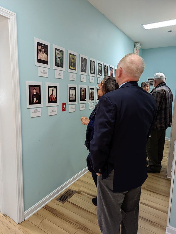 People looking at framed photos