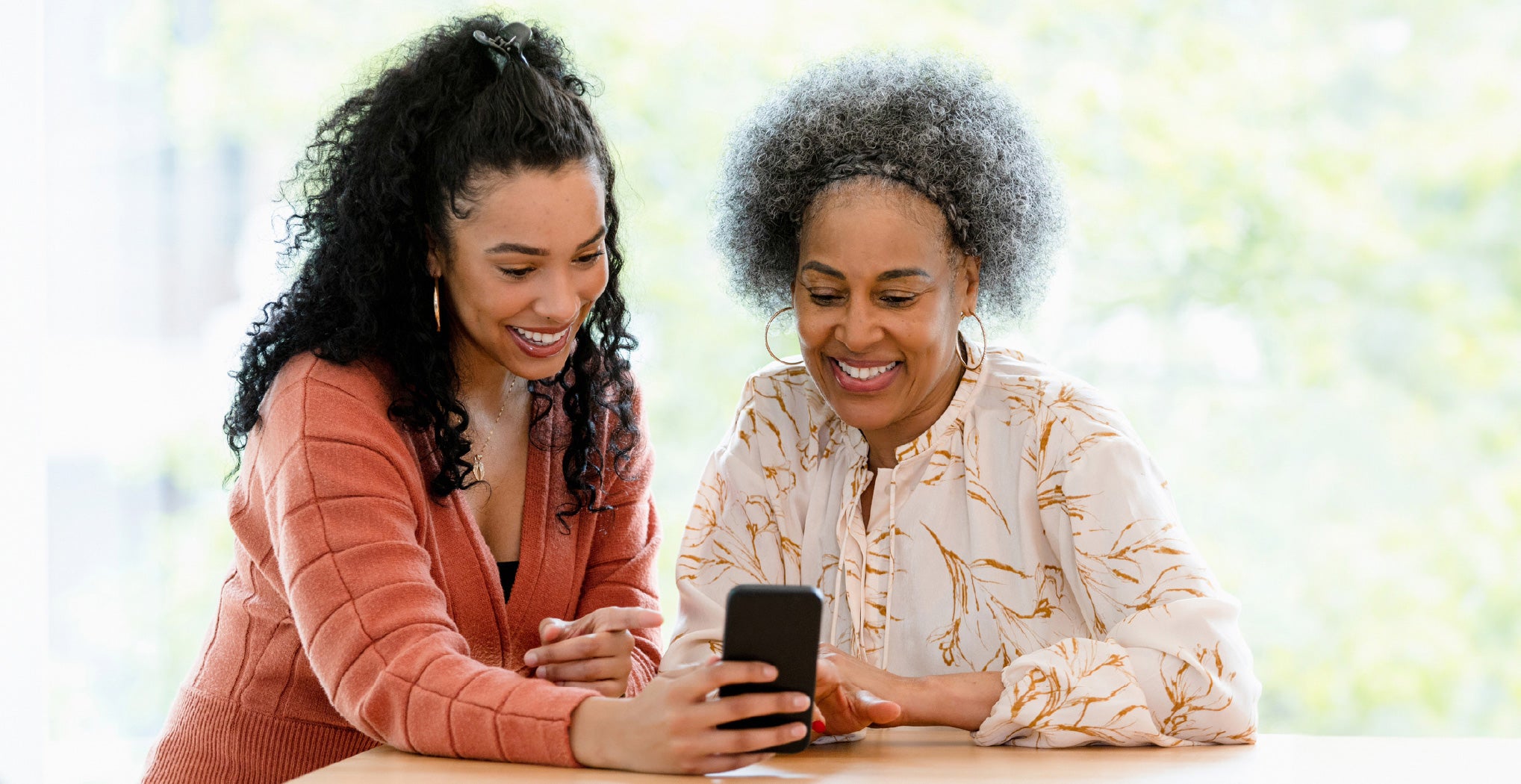 two women looking at cellphone