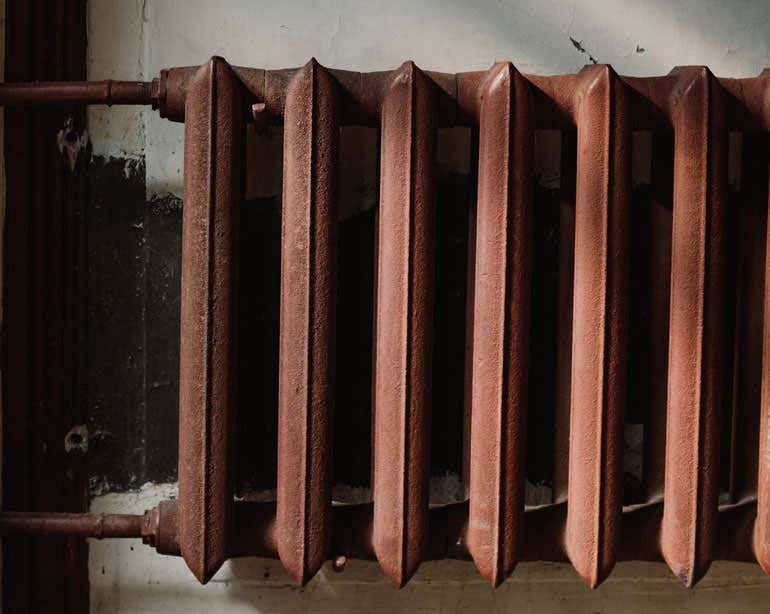 A close up shot of a home radiator in an older home.