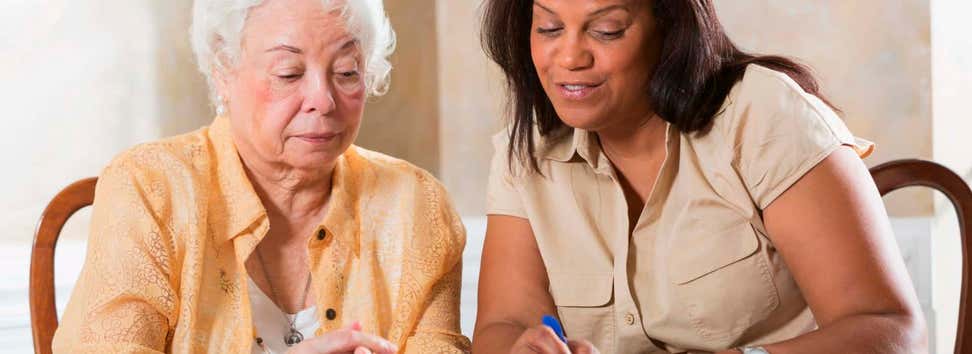 Senior woman getting benefits counseling from advisor
