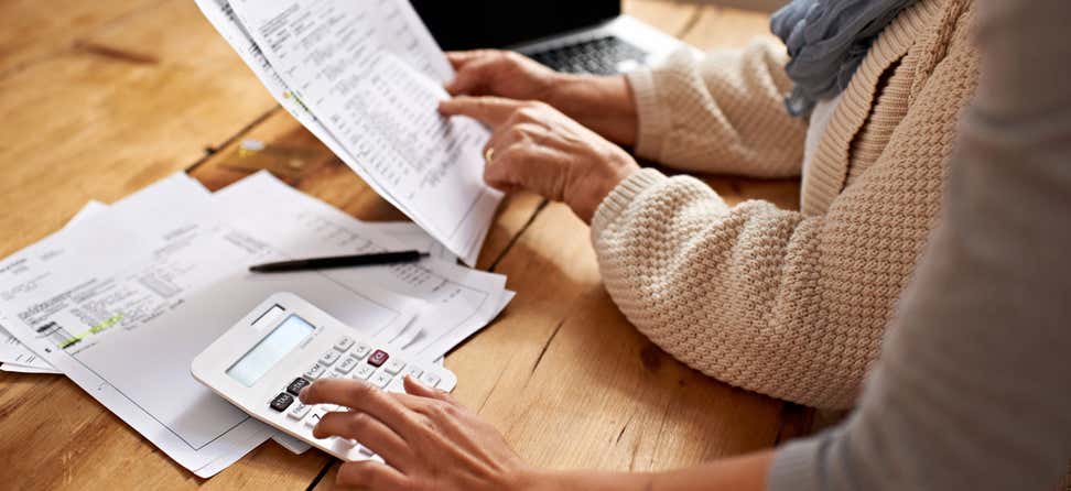 Cropped view of a senior woman receiving help with her finances.