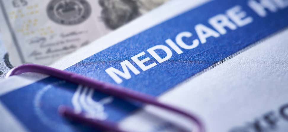 Close up shot of a Medicare card that's paper-clipped to an important healthcare document.