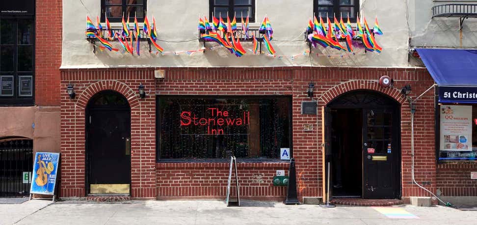 The Stonewall Inn with Pride flags waving. 