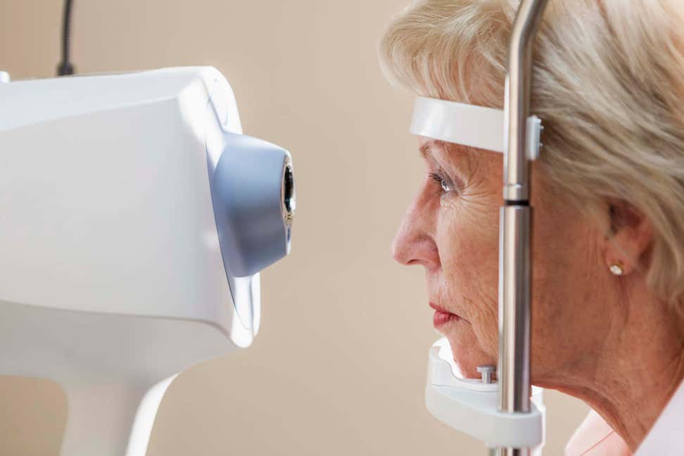 An older Caucasian woman is getting an eye exam.