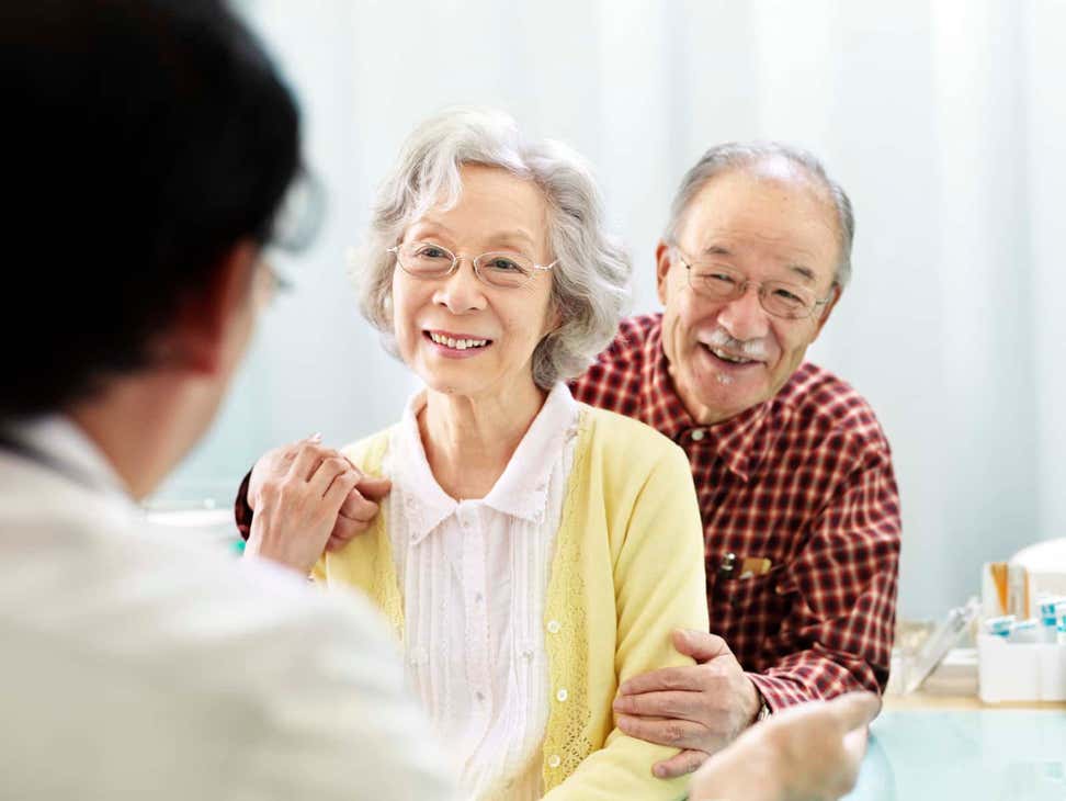 Older Asian couple visiting doctor's office