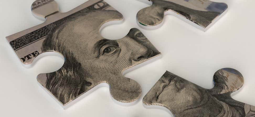 A close-up of a hundred dollar bill puzzle, with the majority of Ben Franklin's face showing.