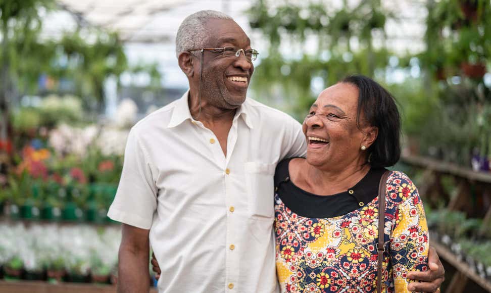 Senior AfricanAmerican couple exploring a greenhouse together.