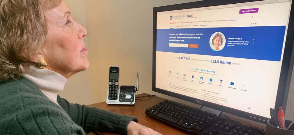 An older caucasian woman is reviewing her options on NCOA's BenefitsCheckUp website.
