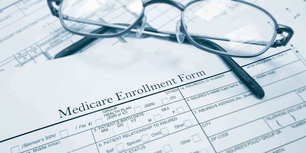 Glasses on top of a Medicare Enrollment Form