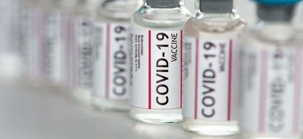 Up close shot of several COVID-19 vaccine vials placed in a row.